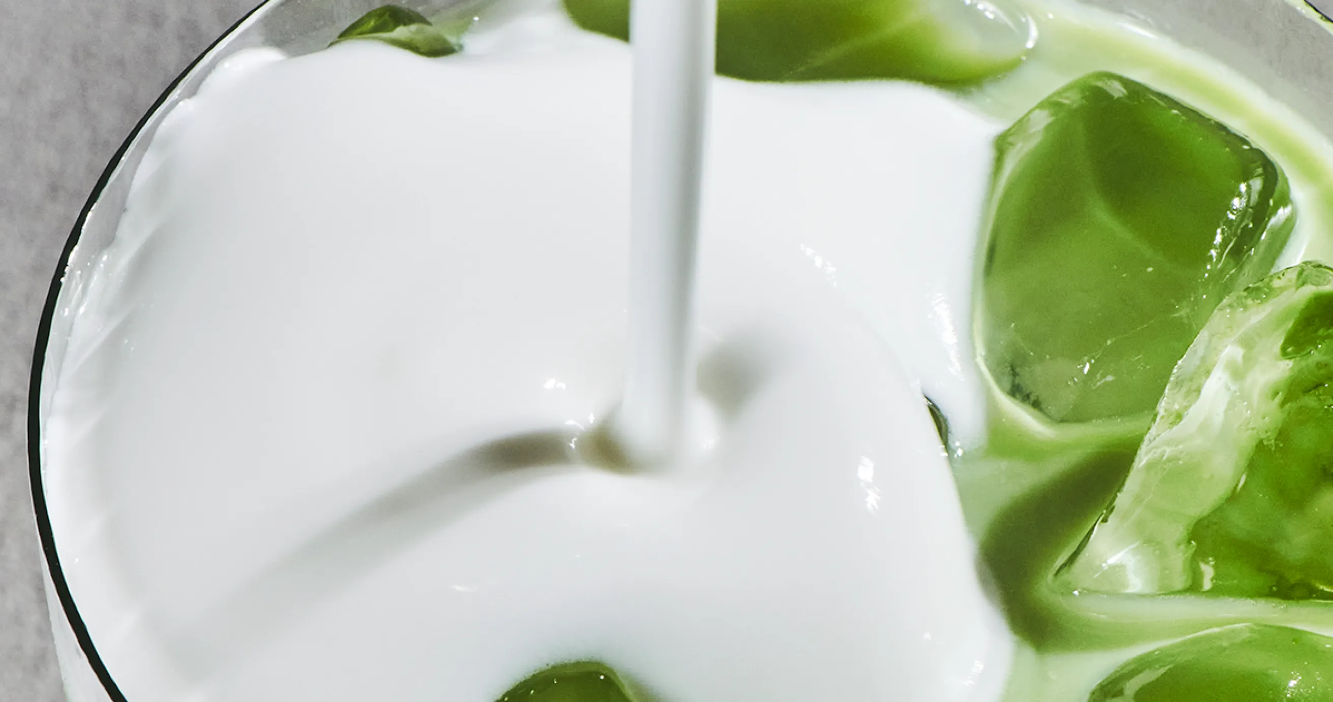 A close up of our new Iced Vanilla Protein Matcha Cold Foam being poured
