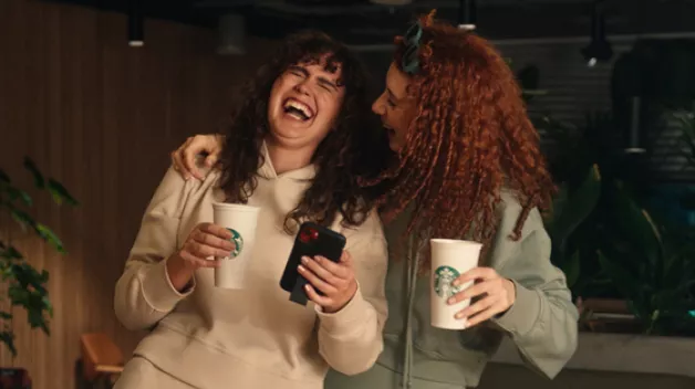 Two girls enjoying oat lattes 